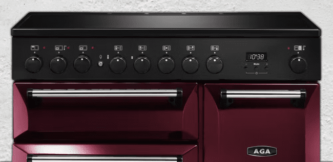An image of a AGA Rangemaster cranberry range cooker.