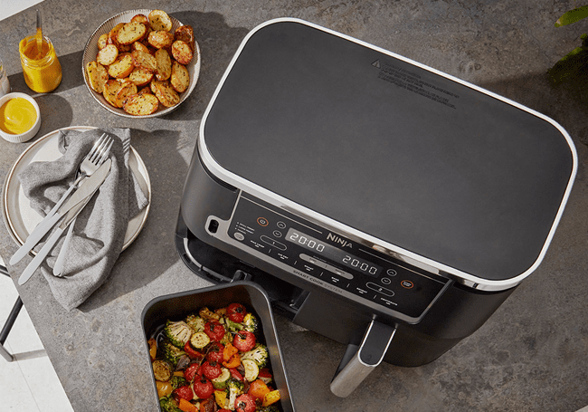 Ninja Foodi air fryers cook food up to 75% faster than fan ovens. Pictured here is a dual zone Ninja air fryer.