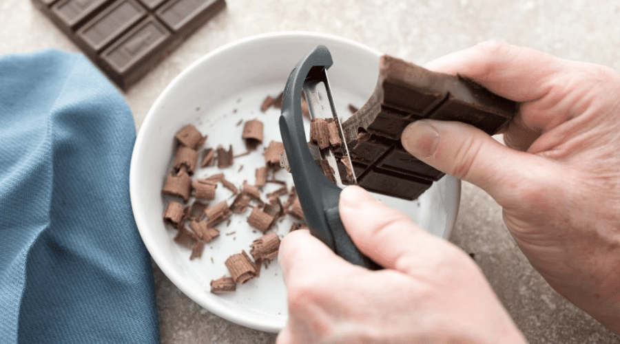 Using a peeler to peel chocolate