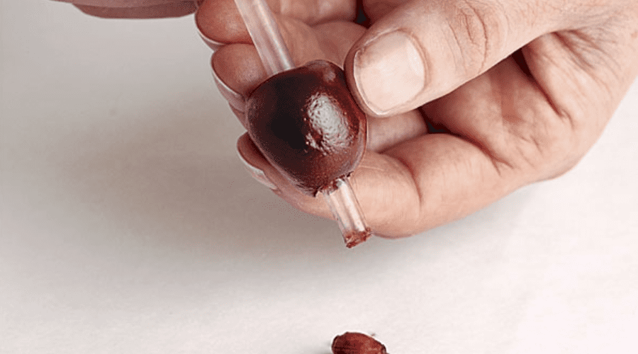 Using straw to remove cherry pit