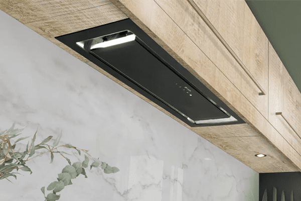 Lifestyle image of a Caple canopy hood in black, positioned above a black Caple induction hob.