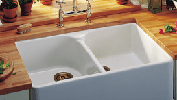Image of a farmhouse style kitchen with wooden worktops and the Franke VBK720 white Belfast sink