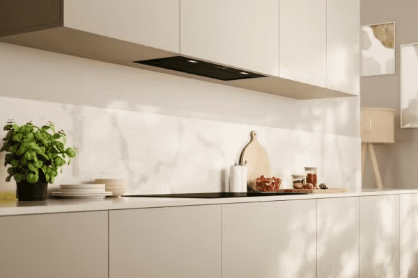 NEFF canopy hood in black, installed in a cream kitchen with a black induction hob