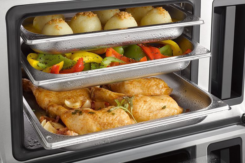 a variety of food cooking in a steam oven