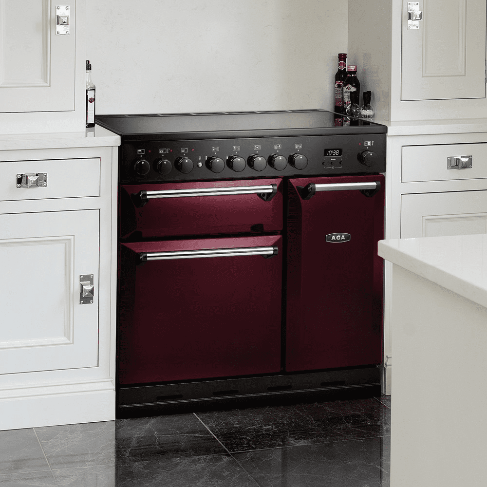 An AGA Masterchef range cooker finished in cranberry in a modern, white kitchen.