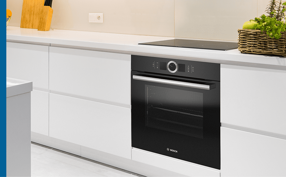Close up of a black Bosch built in single oven in a white modern kitchen