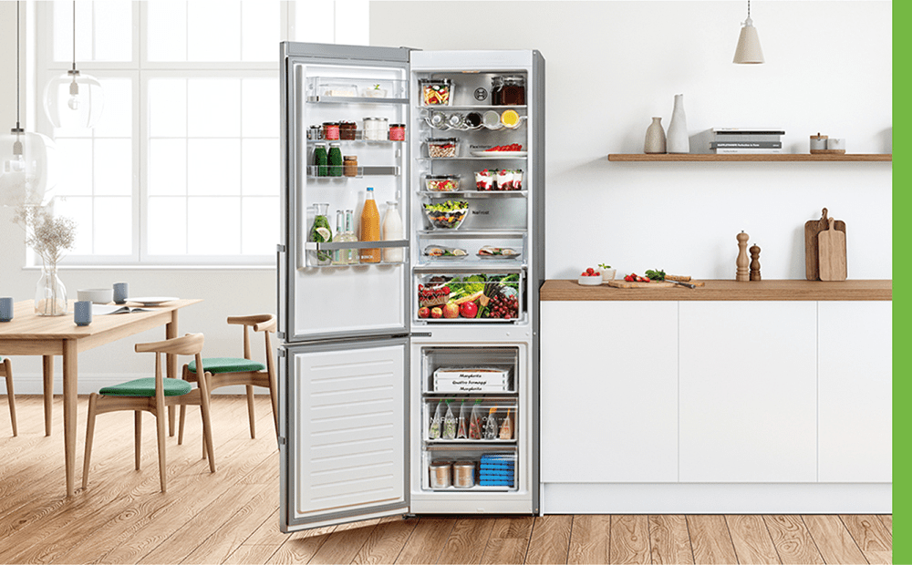 Image of a Bosch fridge freezer with the doors open. Inside the fridge and freezer are lots of brightly coloured chilled and frozen food.