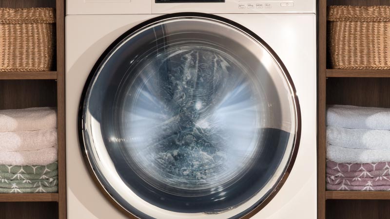 A white Haier washing machine in use. The drum appears sparkling to emphasise how hygienically clean your washing machine can be with Haier.