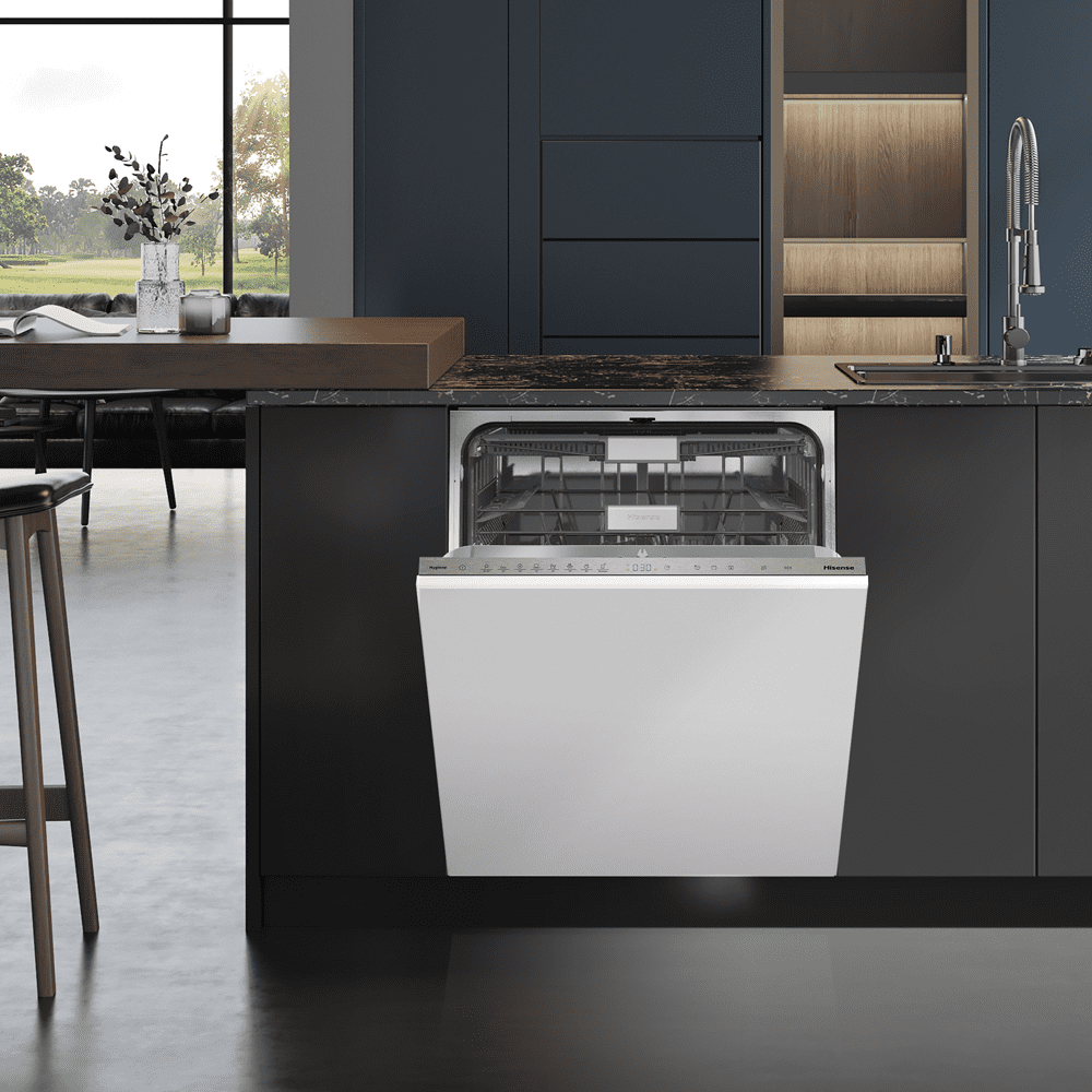 Lifestyle image of a white Hisense dishwasher in a dark blue and grey kitchen.