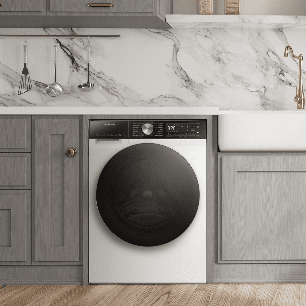 A lifestyle image of a grey and white marbled laundry room featuring a white Hisense washing machine.