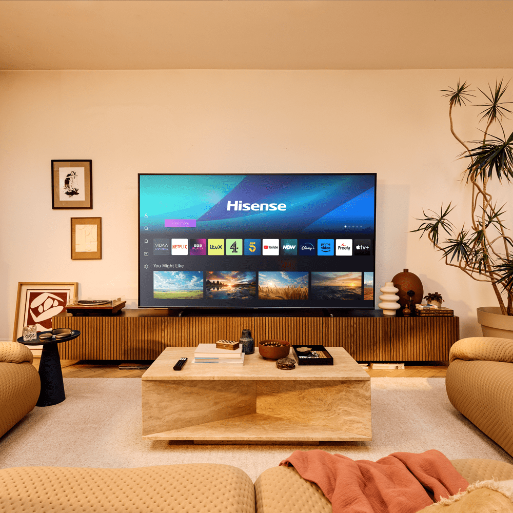Image of a large Hisense TV in a cosy and warm looking living room.