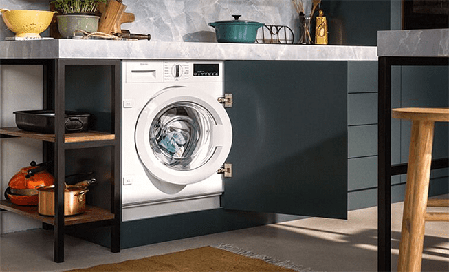 A NEFF Washing machine positioned behind dark grey kitchen cabinetry.