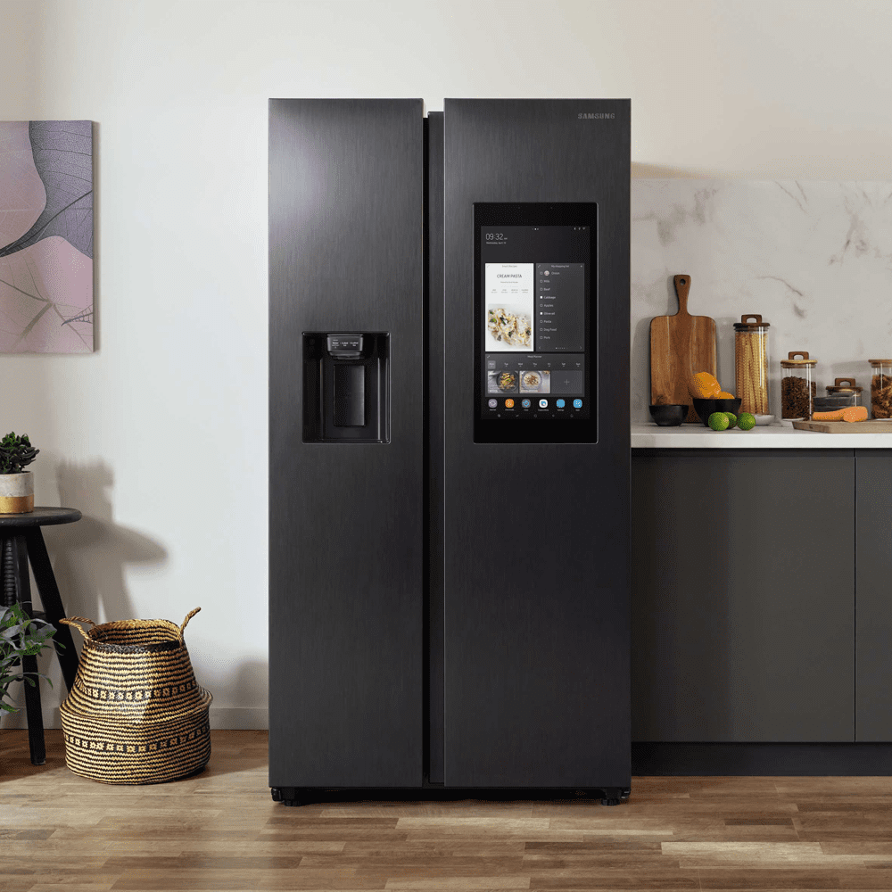 Close up of a Samsung Family Hub American style fridge freezer in Black Steel, in a white and grey kitchen.
