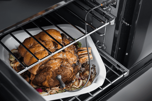 Image of a joint of meat cooking in an AGA Masterchef range cooker, using a meat probe to check the temperature of the centre of the meat