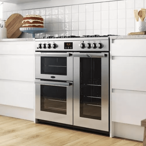 Close up of a stainless steel Belling range cooker in a white kitchen