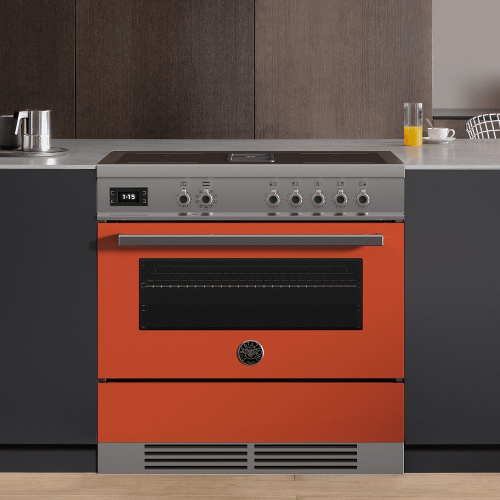 An orange Bertazzoni induction range cooker in a grey kitchen