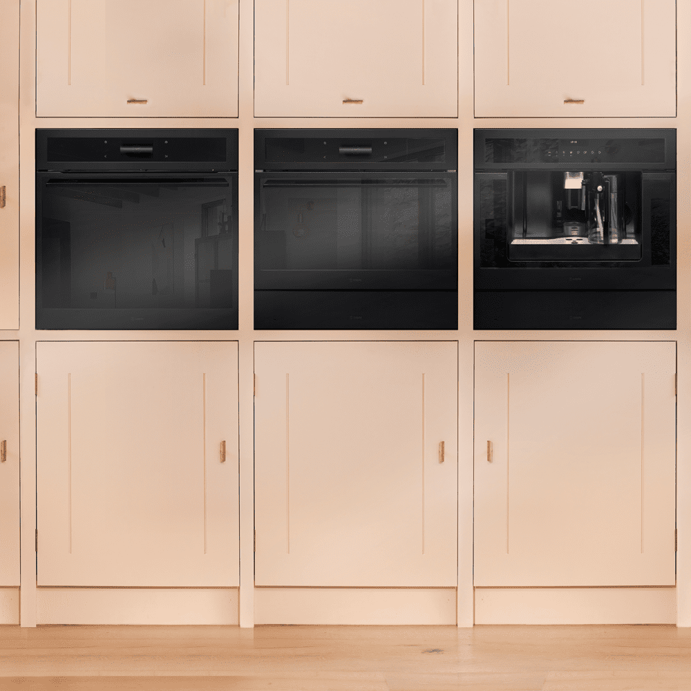 A bank of Caple Sense appliances fitted in a dusky pink kitchen