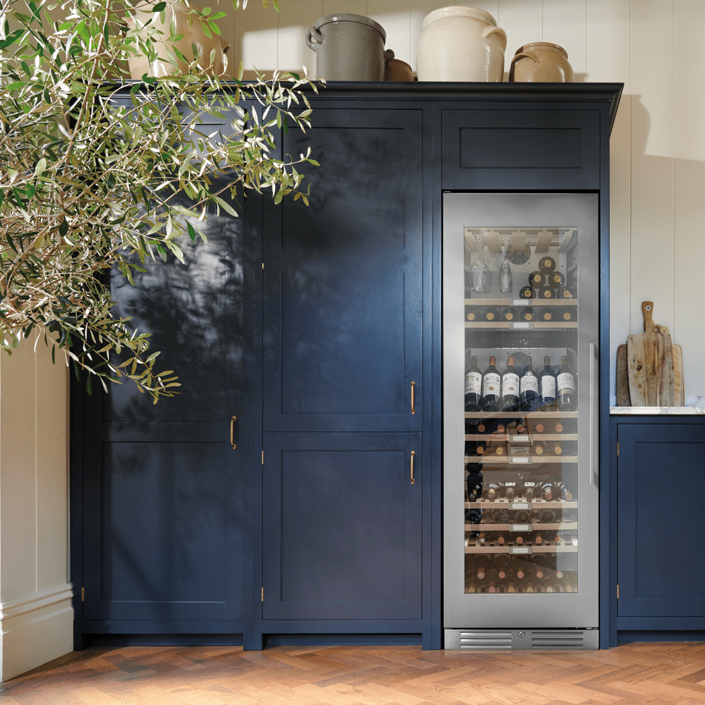 Large Caple wine cooler integrated into dark blue cabinets