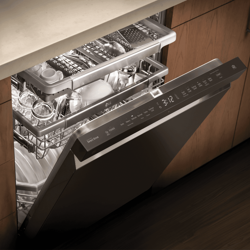 Close up of the inside of an LG dishwasher with the door slightly open. Inside are clean dishes and glassware.