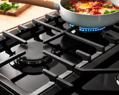 Close up image of a Farmhouse dual fuel range cooker hob top to highlight the cast iron pan supports