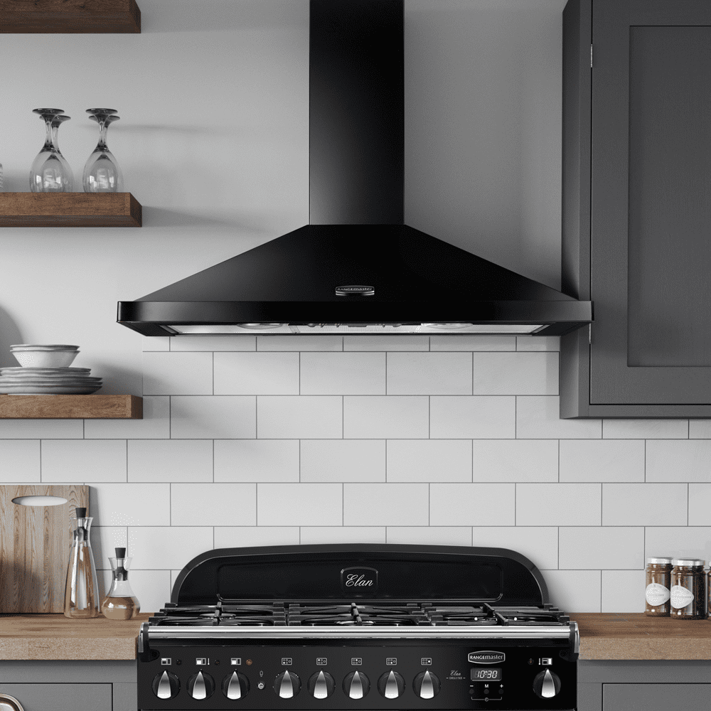 Image of a black Rangemaster chimney hood, positioned above a black Rangemaster dual fuel range cooker. Ina white and grey kitchen with wooden worktops.