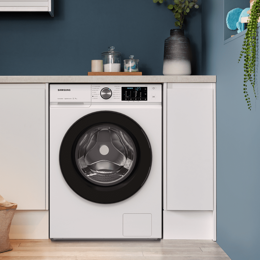 Samsung white freestanding washing machine positioned in a white and blue utility room.