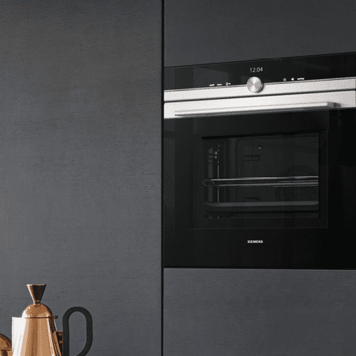 Close up of a built in Siemens oven built into a tall housing unit