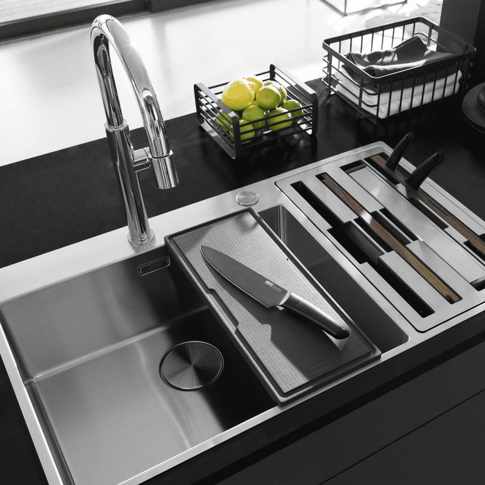 Close up of the Franke Box Centre sink featuring a chopping board and knife.