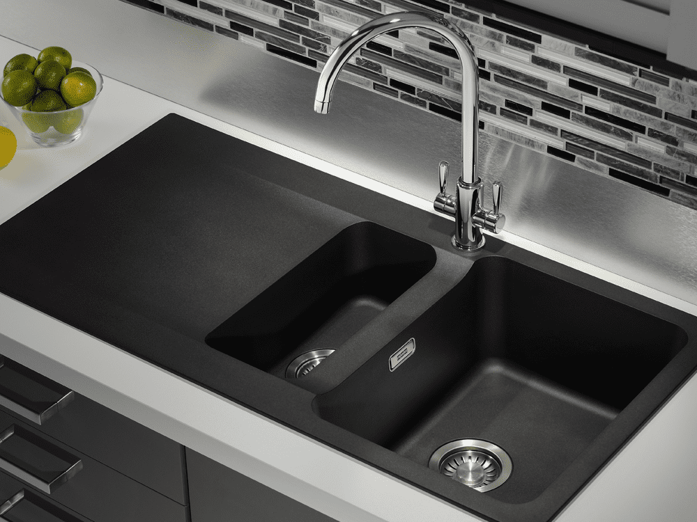 Close up of a Franke Tectonite sink in black, inset on a grey worktop.