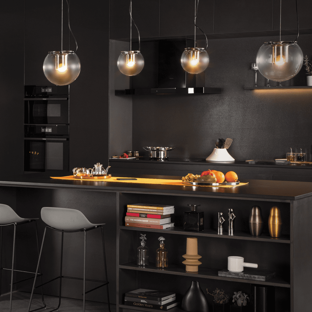 Image of a black kitchen featuring mood lighting and Haier built in cooking appliances