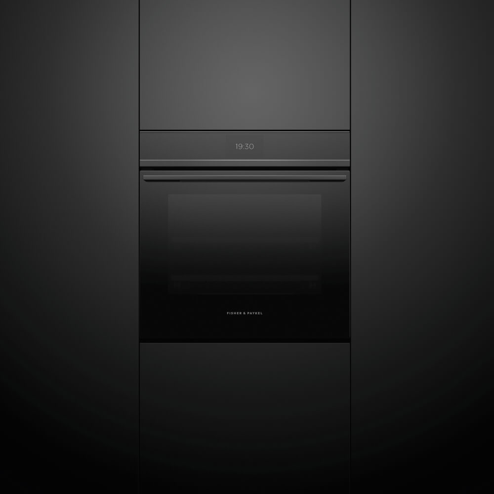 Close up ambient image of a Fisher & Paykel oven positioned in a black tall housing unit