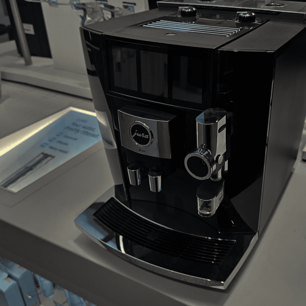 Close up of a Jura freestanding coffee machine in black, in our showroom