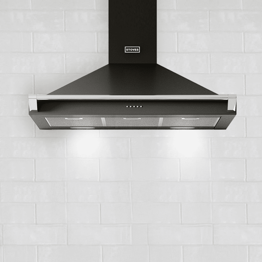 Image of a Stoves chimney hood in black, against a white brick wall