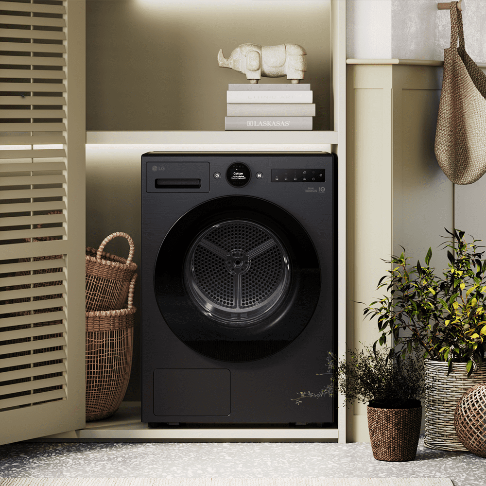 Close up of an LG tumble dryer finished in black. Positioned in a beige and green utility room.