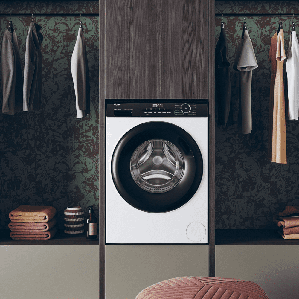 White Haier washer dryer positioned in a dark wooden utility room.