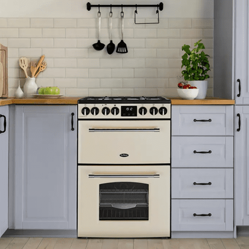 Belling freestanding cooker in cream, fitted within a kitchen with utensils